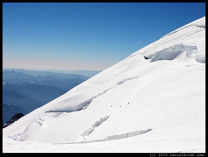 Climb of Mount Rainier: party of three on the high traverse below the bergschrund