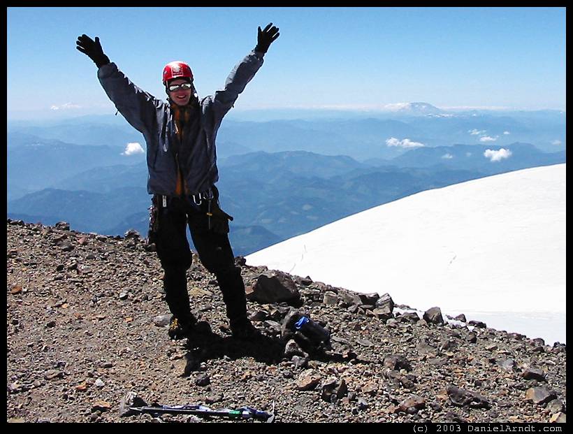 Climb of Mount Rainier: Daniel on the summit with Mount St Helens in the background